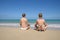 Oung women meditating on the tropical beach