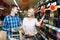 Ñouple of customers purchasing at wine section in supermarket