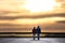 Ouple hand in hand with sundown plain background composing