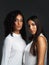 Our beauty is our confidence. Portrait of two attractive young women wearing white blouses posing closely together