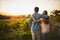 Our farm is a labour of love we live for. a young couple walking through their crops while holding each other and