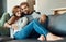 We are at our happiest when were together. Full length shot of an affectionate young couple relaxing on their sofa at
