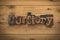 Our story, phrase written with vintage printing blocks on rustic wood background