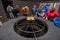 Ourist watching cooking demonstration in Timanfaya volcanic national park in Lanzarote, Canary islands, Spain.