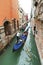 Ourists floating in gondola in canal in Venice