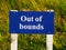 Out of bounds sign on golf course bold white lettering on royal blue background