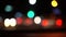 out of focus beautiful glittering blurred bokeh of cars and traffic lights at night. Blurred city traffic jam on city