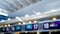 Out of focus image of display on top of flight check-in zone in airport terminal