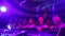 Out of focus night club crowd proping up DJ\'s deck