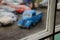 Out of focus old blue car from a window at a car cemetery