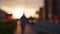 Out of focus sunset background of the city, embankment street, cars and people on the city street