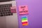 Out of office - message on pink sticky note on work table