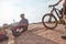 Out to cycle, be back later. two athletic men taking a break while mountain biking through the wilderness.