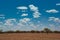 The outback of Australia under a blue sky and lenticular clouds