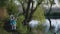 Outdoor activities, cute boys by river play with sticks in water