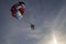 Outdoor activities, skydiving, Skydiver flying with a colorful parachute by speed boat on sea