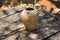 Outdoor ancient pottery jug on weathered wood background