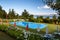 Outdoor area with pool, lake view and green grass