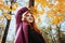 Outdoor autumn portrait of happy smiling plus size red hair woman in coat walking in fall park.