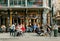 Outdoor bar with happy customers, drinking people with food on old city street