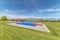 Outdoor basketball court at a park with view of snow capped mountain and lake