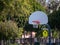 Outdoor basketball hoop sitting on a court in a school zone play