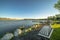 Outdoor bench overlooking a shiny lake with swimming ducks bridge and deck