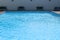 Outdoor blank swimming pool with water wave summer background