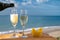 Outdoor breakfast with Spanish cava sparkling wine and pineapple with view on blue sea and sandy beach in Marbella, Costa del Sol