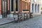 Outdoor cafe with chairs, outdoor restaurant. Ancient architecture, narrow streets and cobblestone pavement