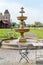 Outdoor cafe terrace with fountain. Empty chairs in cafe or restaurant on summer day. Restaurant terrace in small European city