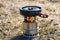 Outdoor camping cooking on solid wood burner with fire. frying pan with lead on it