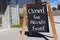 Outdoor chalkboard sign reading closed for private event