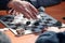 Outdoor checkers tournament on paper checkerboard on table, close up players hands