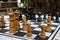 Outdoor chessboard with black and yellow figures with unfocused background. Competition and strategy concept. Intelligent sport.