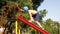 Outdoor children activities. Kid climbing slider at playground