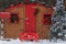 outdoor Christmas decoration with Santa post office with postbox, garland, Christmas tree on snow forest background