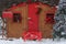 outdoor Christmas decoration with Santa post office with postbox, garland, Christmas tree on snow forest background