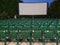 Outdoor Cinema: Empty Green Seats and White Screen