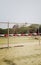 An outdoor click birds sitting on pole of a tent arrangement in college ground