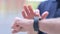 Outdoor Close Up of Hands of Middle Aged Man Scrolling on Smartwatch