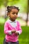 Outdoor close up portrait of a cute little young black girl