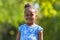 Outdoor close up portrait of a cute young black girl - African p