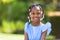 Outdoor close up portrait of a cute young black girl - African p