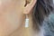 Outdoor detail of female ear wearing beautiful elegant earring