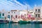 Outdoor dining by waterfront, fishing boat harbour of Naoussa, Paros island, Greece.