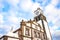 The outdoor facade of St. Sebastian Church, Igreja Matriz de Sao Sebastiao, in Ponta Delgada, Azores, Portugal. White clock tower