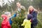 Outdoor Family Choosing Christmas Tree Together