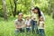 Outdoor family with kids on green grass.