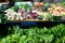 An outdoor farmers market with assorted fruits and vegetables